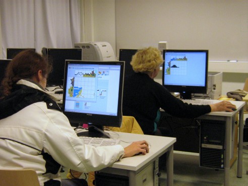 Students solving a Color Pic-a-Pix on their computers at different paces, all are very concentrated