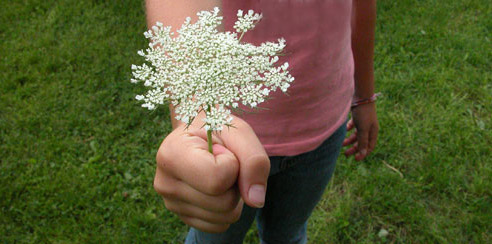 A girl holding a flower with mathematical patterns
