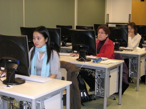 Students solving a Color Pic-a-Pix on their computers at different paces, all are very concentrated