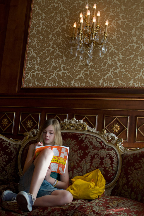 Cleo takes a Sudoku break on the hotel lobby sofa. Photographer: Franco Biciocchi